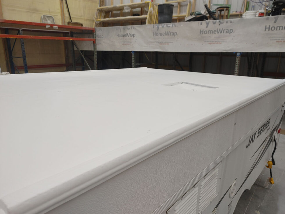 Pop Up camper having roof repaired after hail damage