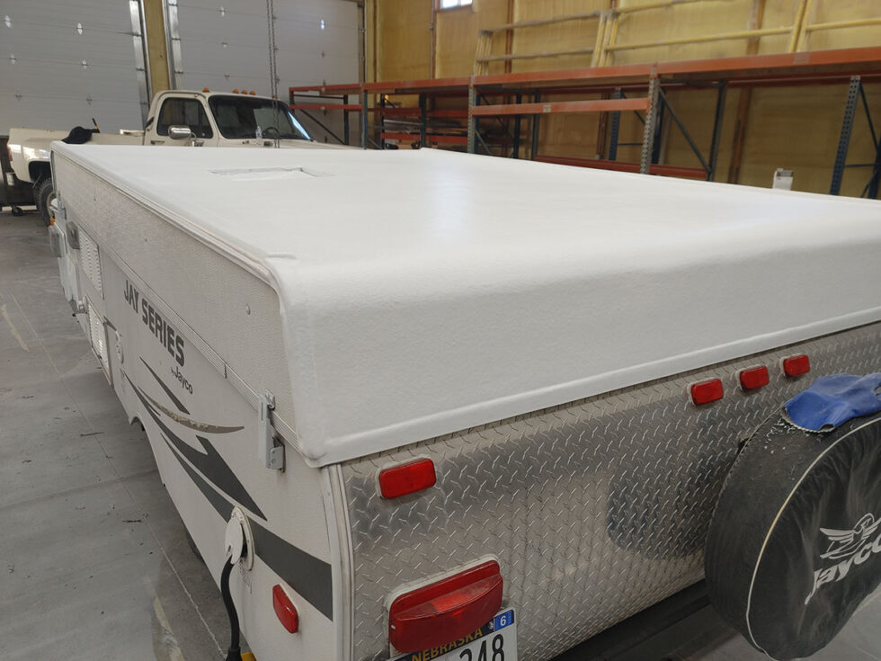 Pop Up camper having roof repaired after hail damage