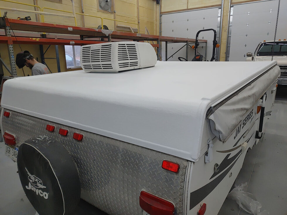 Pop Up camper having roof repaired after hail damage